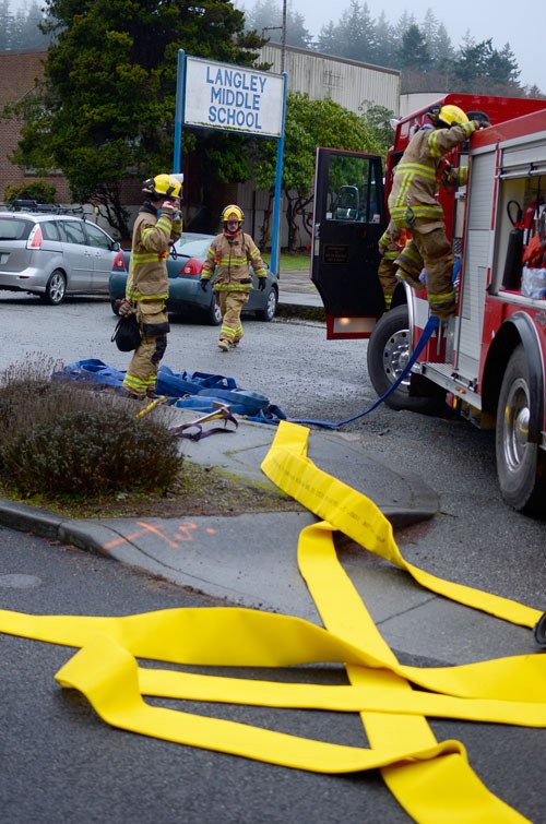 South Whidbey Fire/EMS firefighters clean up after investigating reports of a fire at Langley Middle School Monday. The campus was evacuated