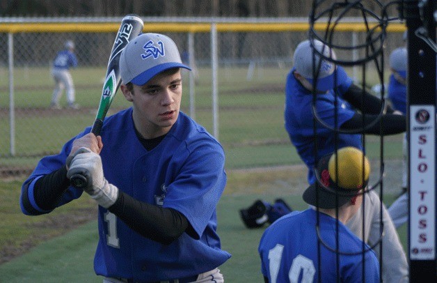 Ben Jacobson-Ross eyes the ball during batting practice at South Whidbey High School. The Falcon senior was on the field with 20 teammates on Monday