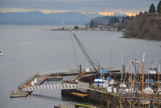 Workers put on the final touches for the South Whidbey Harbor expansion project on Thursday