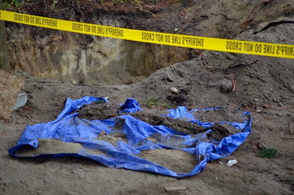 Human remains found at a construction site in Freeland last week sit covered by a tarp Monday in wait of a state expert from the Department of Archaeology and Historic Preservation. The expert was set to examine the bones Tuesday.