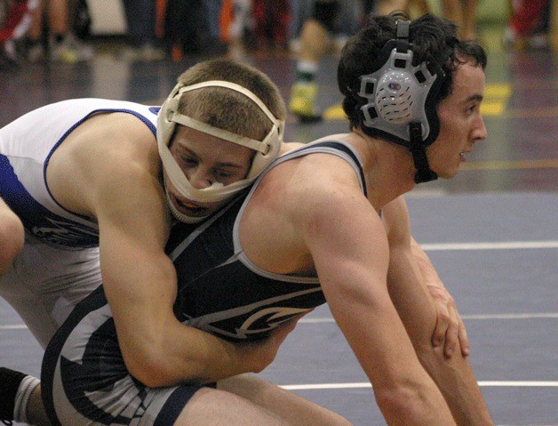 Evan Thompson prepares to take down Nick Foldenhauer in the first round of the Everett Classic  wrestling tournament on Saturday. Thompson defeated Squalicum’s Foldenhauer 10-4 in three rounds