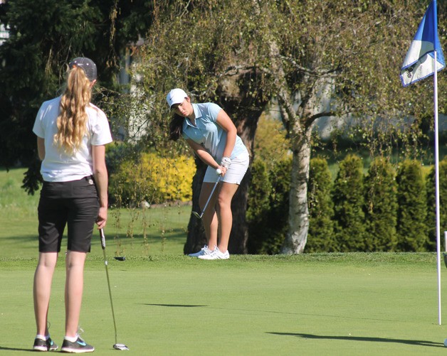 Falcon senior Rosie Portillo chips onto the first hole green at Useless Bay Golf and Country Club on April 20.