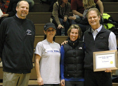 Jim Christensen receives a framed certificate of appreciation from (left to right) South Whidbey High School assistant principal and athletic director John Patton