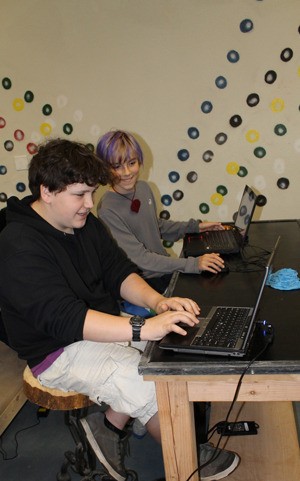 Aidan Dona and Isaiah Giffin work on designs at the MakerTron lab during a session with the HUB