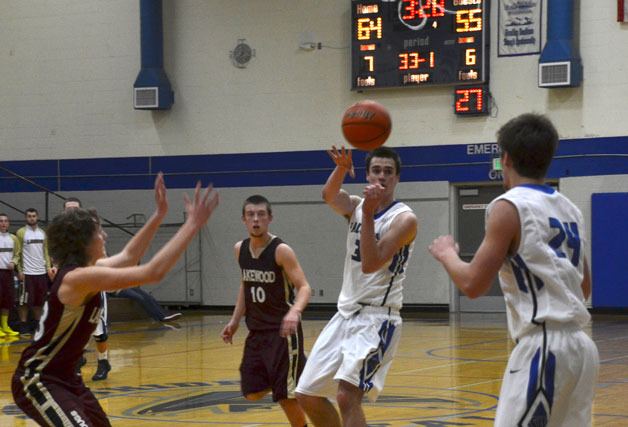 Falcon senior Brandon Asay swings the ball to senior CJ Sutfin behind the three-point arch in the fourth quarter against Lakewood on Tuesday