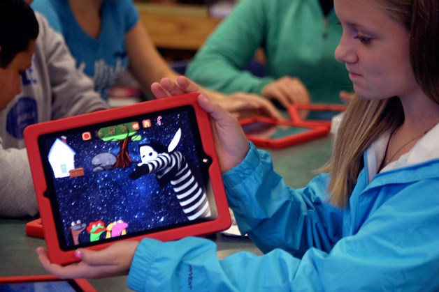 Langley Middle School student Bailey Todd shows off her creations in the Sock Puppets app for the iPad. Bailey and the other 111 seventh grade students will pilot the iPad program this year.