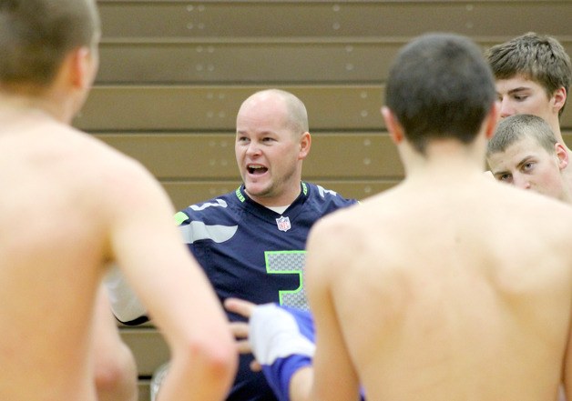 Falcon boys basketball head coach Scott Collins addresses the varsity and junior varsity squads during practice Thursday morning. After a short respite during South Whidbey High School’s winter break
