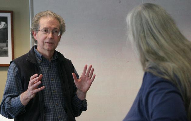 Councilman Robert Gilman talks to Marianne Edain of WEAN after she confronted him about the council’s review of Langley Passage during Tuesday’s special meeting.