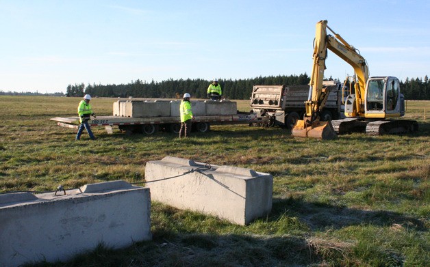 Workers install security blocks at OLF Coupeville.