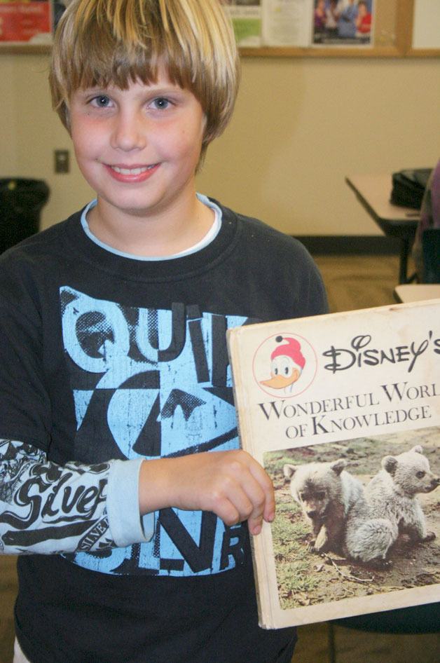 Luke Carlson displays the prize for his winning poem.