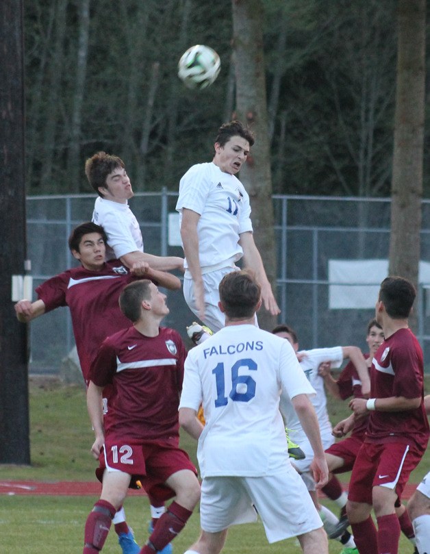 Falcon seniors Jeff Meier and Kai da Rosa (11) leap to try to head the ball in the waning minutes of a Cascade Conference soccer match against Cedarcrest on April 7.
