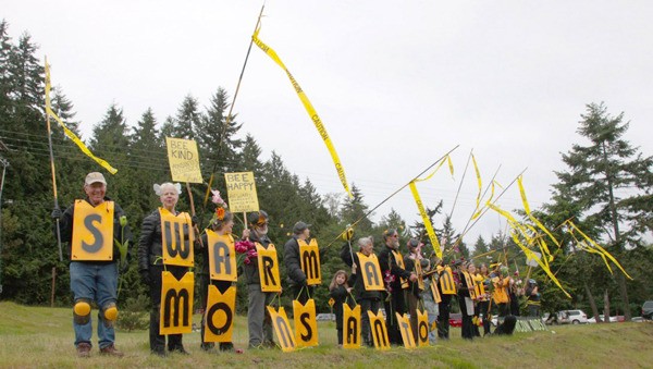 Participants of the Swarm Against Monsanto demonstration in 2015 stand at the Bayview Park & Ride.