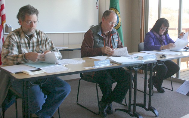 Freeland Water and Sewer District commissioners review the state auditor's report. From the left are Lou Malzone