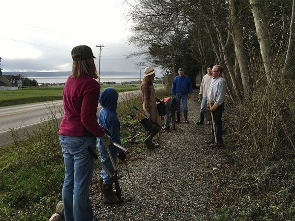 Volunteers help clean Whidbey Camano Land Trust’s newest trail segment March 16.