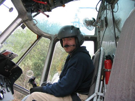 Eric Nance sits in a helicopter used to battle forest fires in California. He hopes to use his piloting skills to help earthquake victims in Haiti.