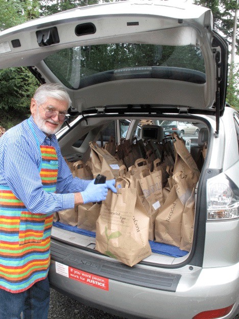 Volunteer Conrad VonDoran prepares to distribute lunches for the Whidbey Island Nourishes’ backpack program.