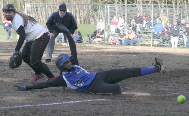 Falcon senior Ellie Greene slides into third for a triple against Cedarcrest on March 25. She tried to score on an in-the-park home run but was tagged out at home plate. Greene finished 3-for-3 at the plate.
