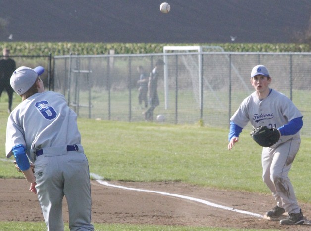 Colton Sterba fields the ball and throws to Falcon first baseman Jack Lewis against Coupeville.