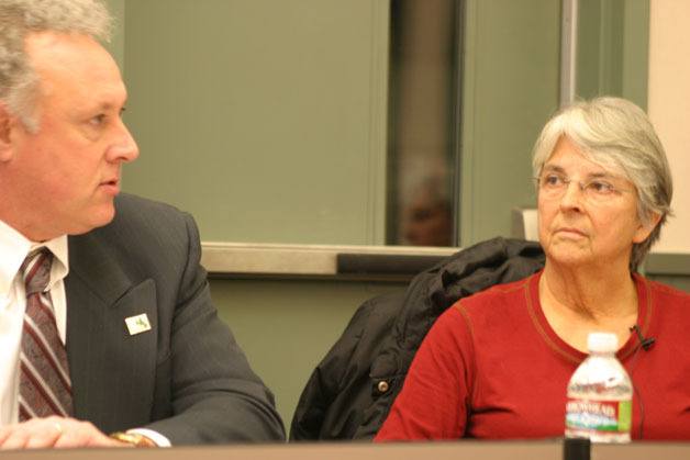 Board Member Linda Racicot listens as School Board Member Damian Greene reads a prepared statement about his support to keep Langley Middle School open during the school board meeting Wednesday.