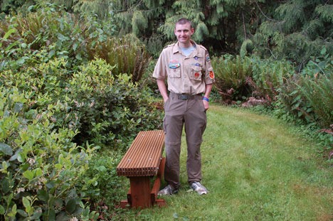 Eagle Scout candidate Jason Neil of Langley with one of five benches he designed and built for Langley Woodmen Cemetery: “I think people will use them.”