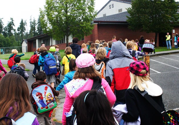 Students head back to South Whidbey Elementary School on the first day of school last September. The Back To School Project hopes to have every student outfitted
