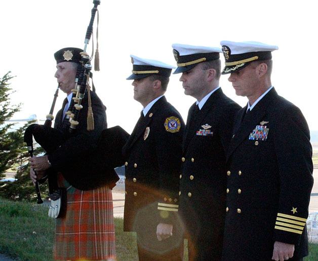 Capt. Mike Nortier joins Whidbey Island Naval Air Station leaders and first responders in a pensive moment during a bagpipe song honoring the fallen.
