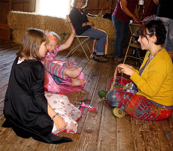 Amelia Deal and Annie Wheat do crafts with Meadow Holtby at the PRIDE parade fundraiser June 5 at the Greenbank Farm.