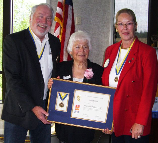 Rotary Club president Rick Brown and Rotarian Linda Senff flank Joan P. Nelson of Clinton