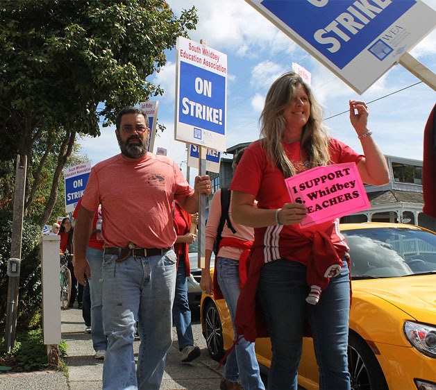 South Whidbey School District teachers may see a pay hike if Gov. Jay Inslee’s recent proposal for a salary increase is adopted by the state Legislature. District teachers successfully negotiated a raise in September when they went on strike. Pictured above is math teacher Tom Sage on a march through Langley during the five-day event.