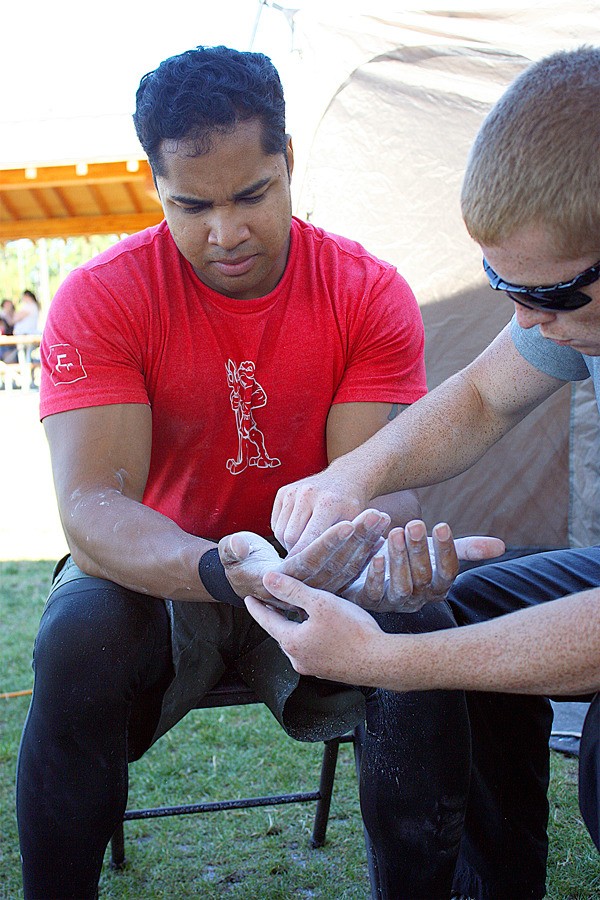 The hands of Navy Petty Officer Michael McCastle are treated with chalk for blisters.