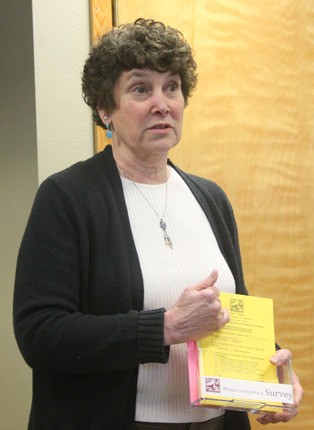 Carolyn Tamler displays the holder for surveys to be distributed around Langley to gather more information about where visitors come from and why they visit the city.