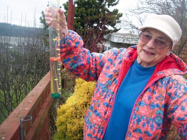 Midge Billig finds another 2 inches of rain in the gauge she has been checking since 1988. Besides a record 50.09 inches in 2012
