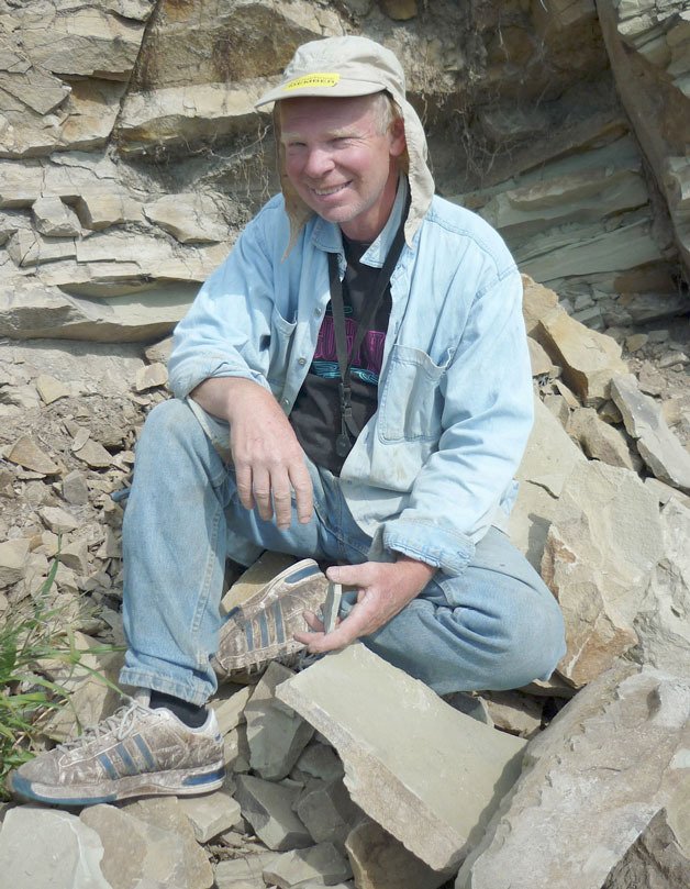 John Elverum collects shale rock at the Stonerose Fossil Beds in Republic