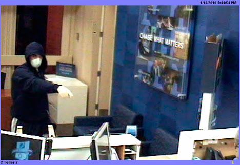 A masked man approaches the counter at the Freeland Chase Bank Thursday during a robbery in this photo released by the Island County Sheriff's Office.