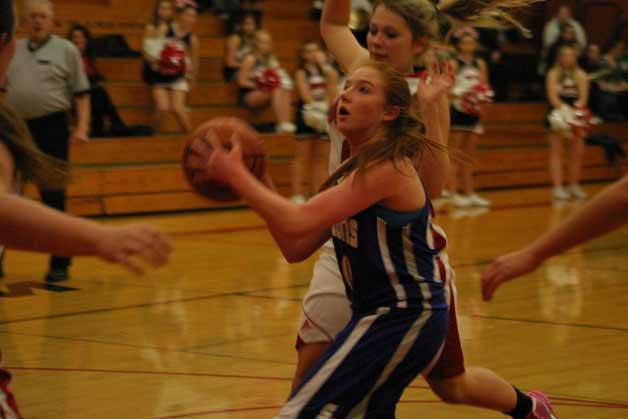 Madi Boyd drives past Wolves junior Breeanna Messner and scores a layup against Coupeville on Dec. 14.