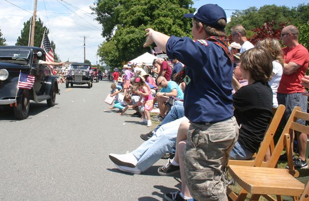 Children clamor for candy thrown from classic cars like these Ford Model As and Model Ts at the Maxwelton Community Club’s Independence Day Parade on July 4.