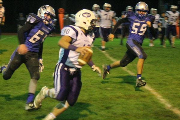 South Whidbey juniors Hunter Newman and Trevor Kleinfelder chase down Nooksack Valley’s Joe McNeely during the Falcons’ season finale on Nov. 6 at Waterman’s Field.