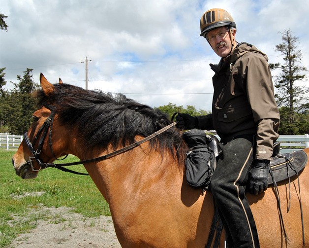 Jerry Lloyd sits on one of his horses during a fundraising event for the purchase of Trillium forest.