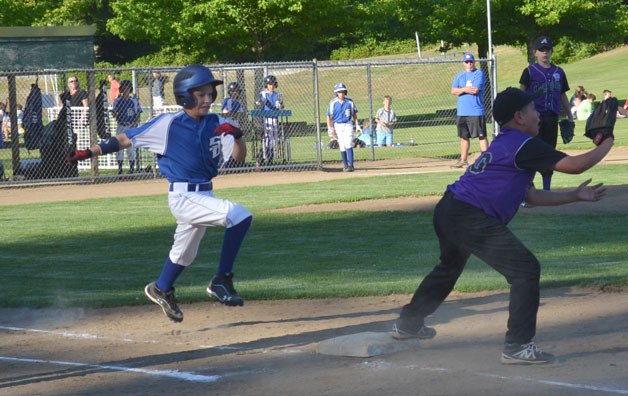 Aidyn Frederick lunges to beat the throw to first base during a game against Anacortes at South Whidbey Community Park. South Whidbey won the Little League District 11 All-Star game