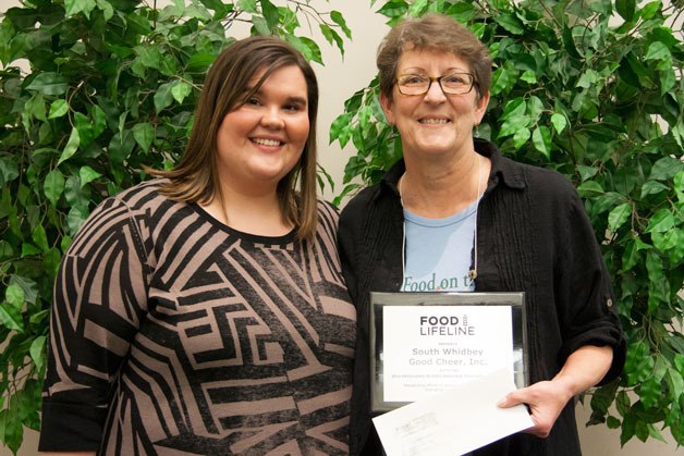 Kathy McCabe (right) receives an award for Excellence in Food Resource Development from Tiffani Kaech