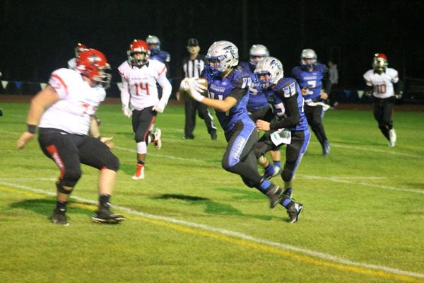 Falcon senior Anthony Eveland returns an interception forced by senior defensive back Charlie Patterson.