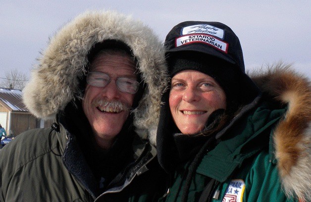 Jean Dieden stands with four-time Iditarod champion Jeff King at Nikolai in 2010. Dieden has  volunteered with the Iditarod as a veterinarian for 20 years.