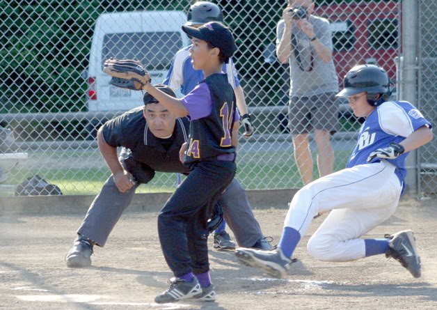Brent Batchelor slides under the tag in the elimination game against North Whidbey on July 1 at South Whidbey Community Park. South Whidbey won the Little League District 11 All-Stars game