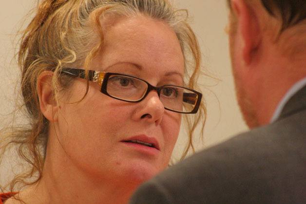 Peggy Sue Thomas listens to her attorney