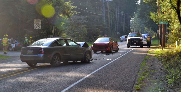 Two of three cars involved in an accident on Brooks Hill Road Wednesday sit damaged at the intersection of Crawford Road. No one was injured but the collision shut down one lane of traffic for about one hour.