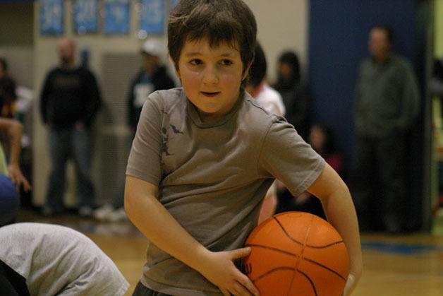 Michael Peterson shows off his basketball skills with a behind-the-back move during the Little Dribblers performance.