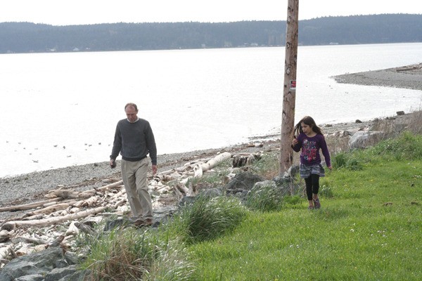 Randy Wall and granddaughter Katrina Brady walk along the beach at Monroe Landing on March 26