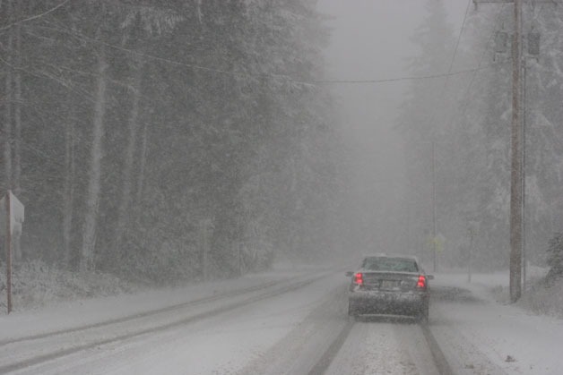 A driver makes slow progress along Maxwelton Road during a heavy snowfall on Wednesday afternoon.