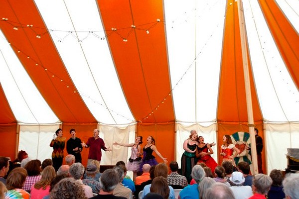Audience members take in the performance inside the Island Shakespeare Festival tent during the 2014 season.