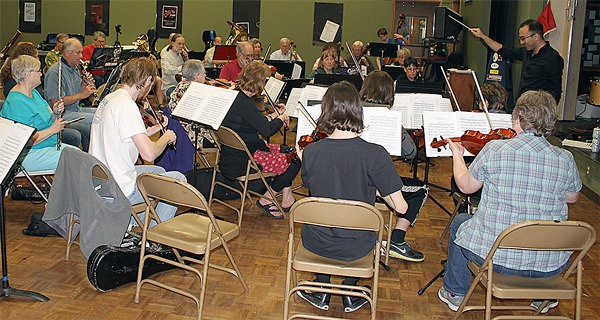 Tigran Arakelyan conducts members of the Whidbey Island Community Orchestra during rehearsal Thursday evening. The group meets each Thursday at South Whidbey High School. They will be performing at Trinity Lutheran Church on Sunday